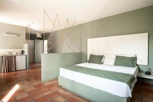 a bedroom with a large bed and a kitchen at Mounda Beach Retreat in Skala