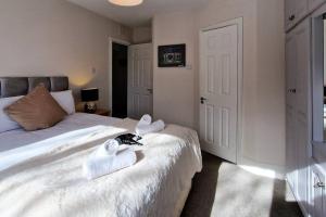 a bedroom with two white towels on a bed at 2 minute walk to LUAS (tram) in Dublin
