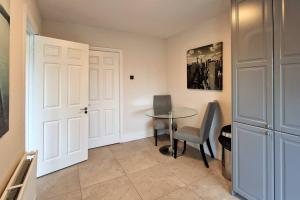 a room with a table and chairs and a door at 2 minute walk to LUAS (tram) in Dublin