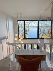 a dining room with a table and a large window at Zegrze Lake Apartament przy Narwi LEKKO z sauną in Zegrze