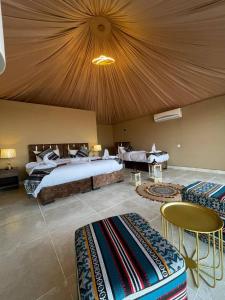 a bedroom with a large bed with a large ceiling at Wadi Rum Bubbles Wissam camp in Wadi Rum