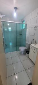 a bathroom with a glass shower and a toilet at Edifício Vitória 1 Apt 203 in Marcelino Ramos +3 photos