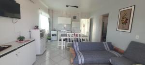 a kitchen and a living room with a couch and a table at Edifício Vitória 1 Apt 203 in Marcelino Ramos