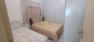 a small room with two beds and a mirror at Edifício Vitória 1 Apt 203 in Marcelino Ramos