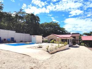 a house with a swimming pool in a yard at Casa Chika, Playa Grande, Private House, Pool, Kitchen, AC in Cuajiniquil