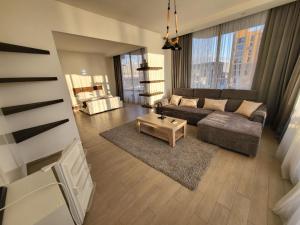 a living room with a couch and a coffee table at Hotel SABA in K'obulet'i