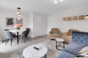 a living room with a couch and a table at Modern 3 BR House near Bicester Village in Bicester