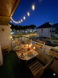 a table with candles and plates of food on a patio at Paraíso de Berria frente al Mar in Santoña +17 photos