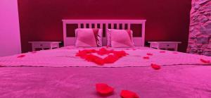 a pink bedroom with a bed with red hearts on it at Instant Evasion in Châtelet