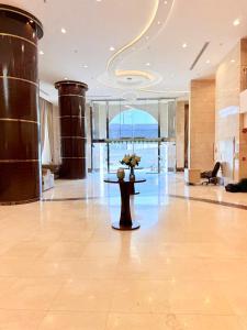 a lobby with a table with flowers on it at Mizab Hotel From Nebras Alhuda in An Naqāʼ +16 photos
