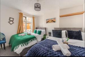 En eller flere senge i et værelse på Ridley Premium Stay