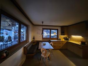 a kitchen with a table and chairs in a room at GG Haus Zillertal in Finkenberg