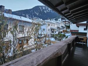 a balcony of a building with a view of a city at GG Haus Zillertal in Finkenberg