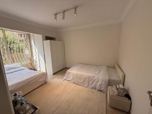 a bedroom with two beds and a window at Garden Home in Sheikh Zayed