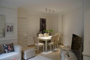 a living room with a white table and chairs at Garden Home in Sheikh Zayed