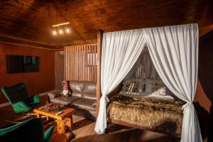 TătăruşiCaseddu SPA Chalet的带床和沙发的卧室