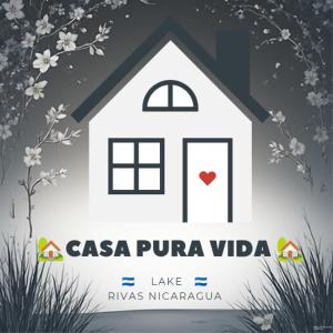 a white house with a red heart on the door at hostal Casa pura vida in Rivas