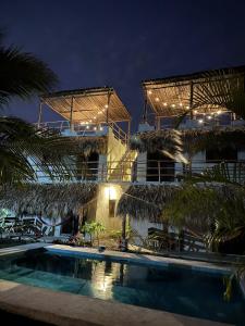 a resort with a swimming pool at night at Mis Hibis in El Naranjo