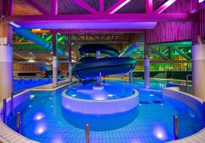 a large swimming pool with a slide in the middle at Bardufoss Panorama in Bardufoss