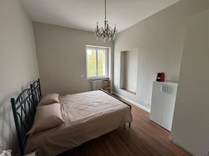 a bedroom with a bed and a chandelier at Ai Cappuccini in Tricarico