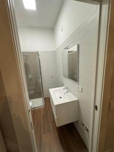 a bathroom with a sink and a shower and a mirror at Ai Cappuccini in Tricarico