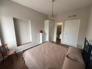 a bedroom with a bed and a chair in it at Ai Cappuccini in Tricarico