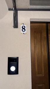 a building with a door with a sign with the number six at Ai Cappuccini in Tricarico