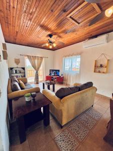 a living room with a couch and a table at Sunset Views Apartment, West End in West End