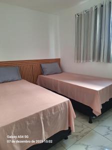 two beds sitting next to each other in a room at New apartment in João Pessoa in João Pessoa