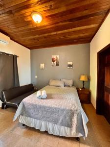 a bedroom with a bed and a couch at Sunset Views Apartment, West End in West End