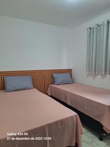 two beds sitting next to each other in a room at New apartment in João Pessoa in João Pessoa