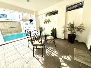 a dining room with a table and chairs and a pool at Grand Retreat in La Paz
