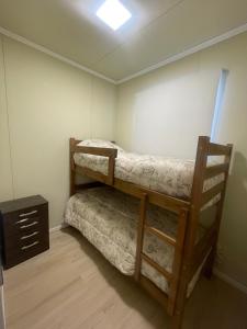 a bedroom with two bunk beds and a dresser at La Barra Apto 4 in Punta del Este