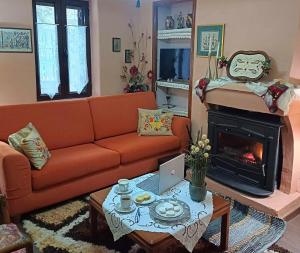 a living room with a couch and a fireplace at Vrachni Stone House in Kalavrita
