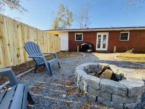 a yard with a chair and a fire pit at Redbud Waterfront (Augusta Canal), king bed in Augusta