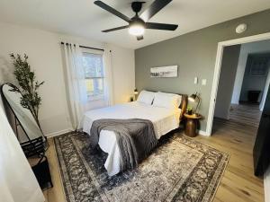 a bedroom with a bed and a ceiling fan at Redbud Waterfront (Augusta Canal), king bed in Augusta