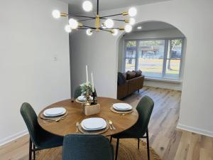 a dining room with a wooden table and chairs at Redbud Waterfront (Augusta Canal), king bed in Augusta