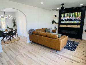 a living room with a couch and a table at Redbud Waterfront (Augusta Canal), king bed in Augusta