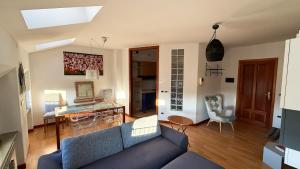 a living room with a blue couch and a table at Riflessi sul Fiume in Cervignano del Friuli