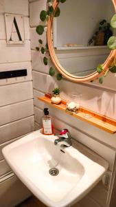 a bathroom with a sink and a mirror at Brusta Stugor in Ödkarby +44 photos