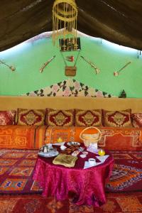 a room with a table with food on it at Maison etoile du desert in Aït Boukha