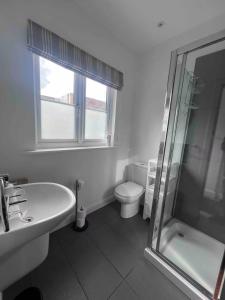 a bathroom with a toilet and a sink and a shower at Stylish One Bed Apartment in Edinburgh