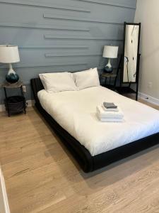 a bedroom with a bed with two lamps on it at Queen Bed with Attached Private Bath in Austin