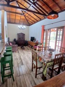 ein großes Wohnzimmer mit einem Tisch und Stühlen in der Unterkunft Casa próxima ao Centro em Tiradentes - MG in Tiradentes