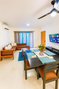 a living room with a table and a couch at Penthouse with Large Rooftop Terrace & Parking in Sosúa +27 photos