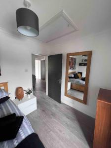 a bedroom with a bed and a mirror at Stylish One Bed Apartment in Edinburgh