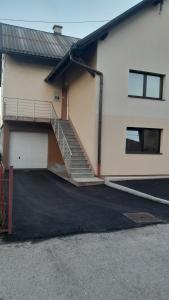 a building with a staircase and a garage at Apartman Vule in Pale