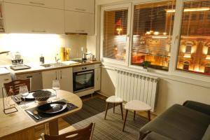 a kitchen and living room with a table and chairs at Mother Teresa Apartments FREE PARKING in Skopje +77 photos