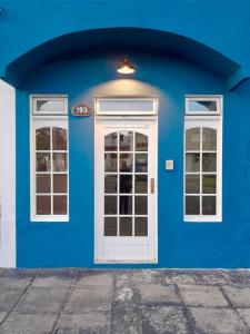 a blue building with a white door and windows at Rocio Club de Mar in Mar del Tuyú