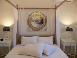 A bed or beds in a room at Melograno Apartments and Studios